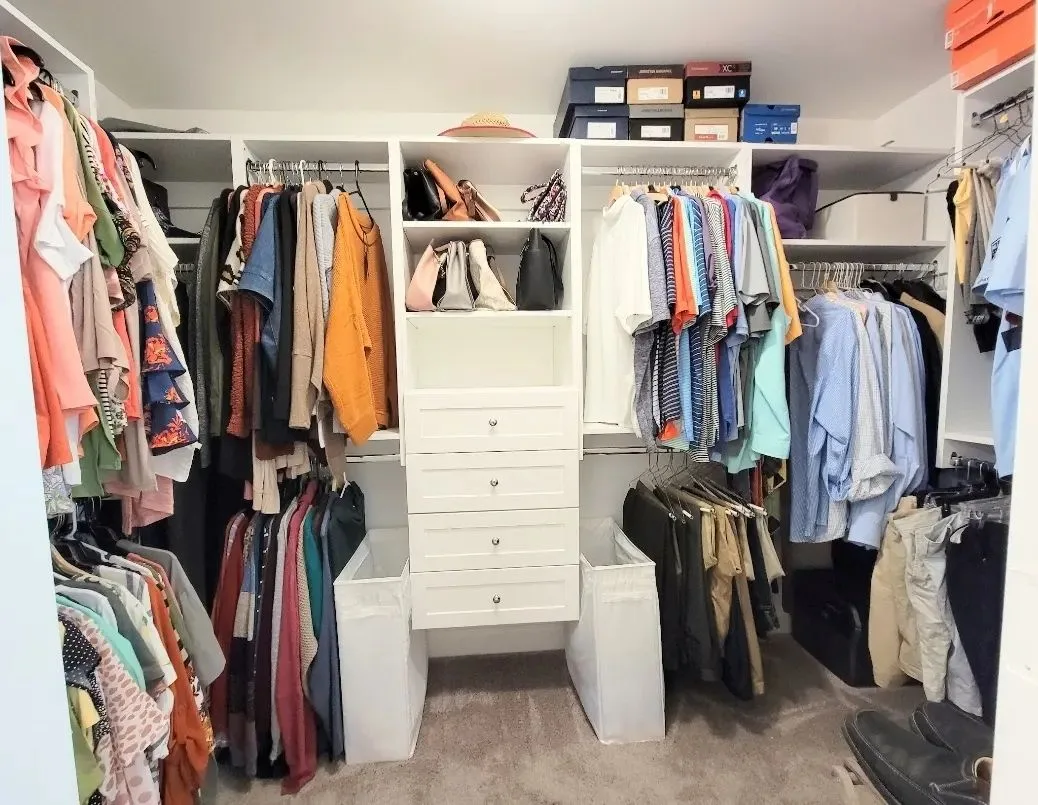 Fully styled walk-in closet with clothes organized