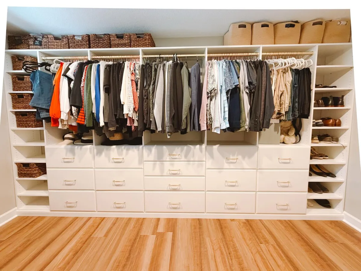 Custom walk-in closet with full wall shelving and drawers