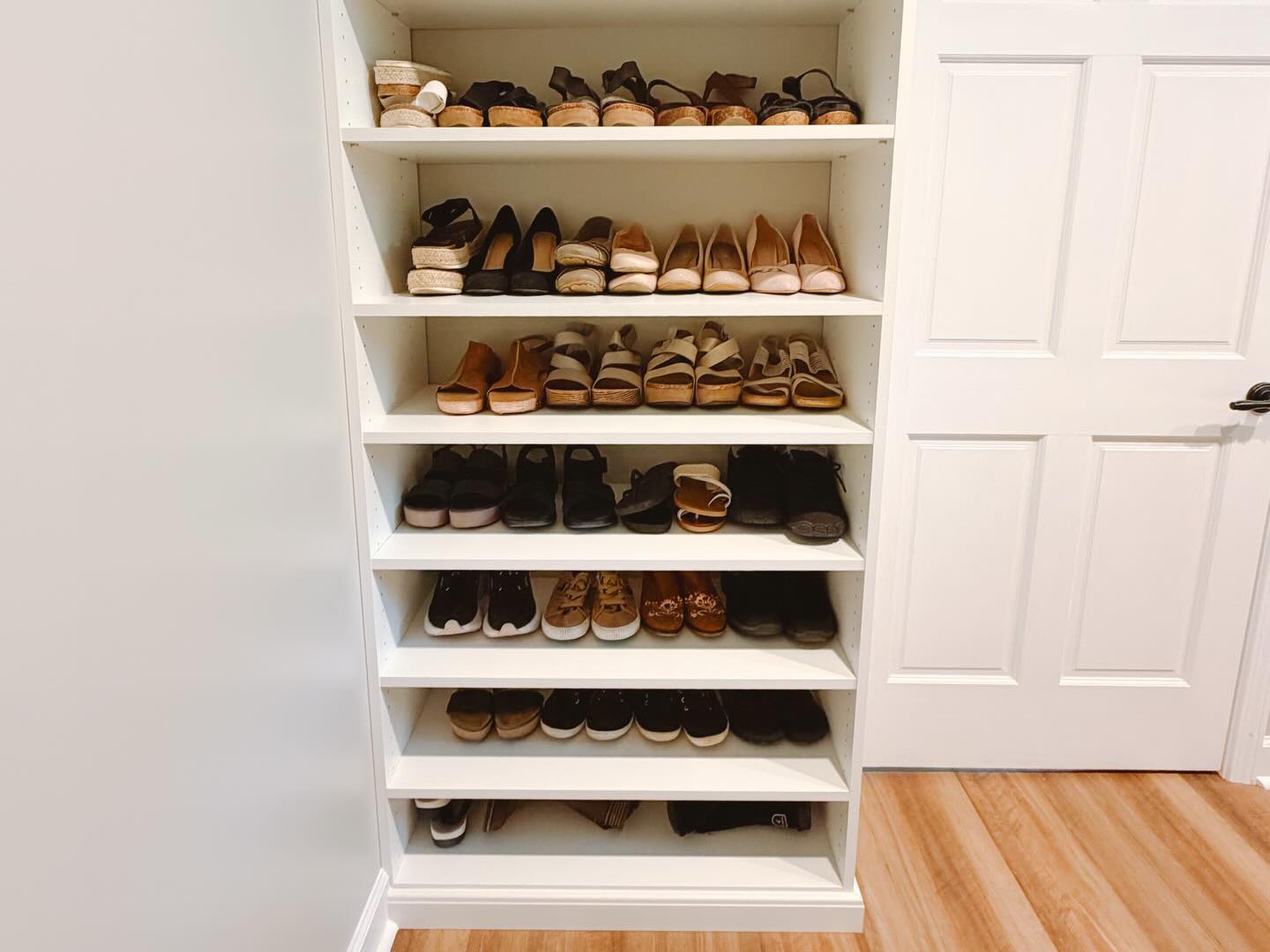Built-in shoe shelving in walk-in closet