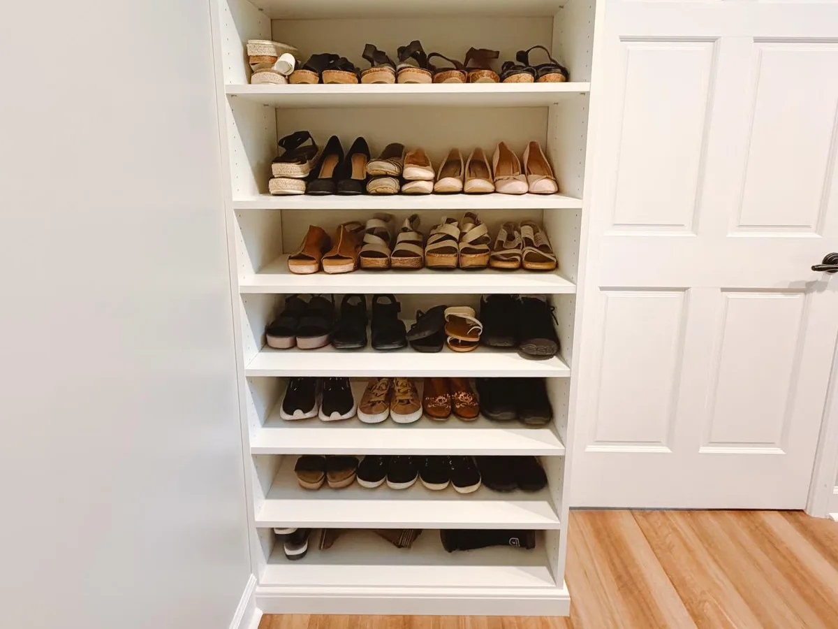 Built-in shoe shelving in walk-in closet